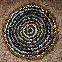 a circular rug made out of different colored objects on the floor in front of a carpet