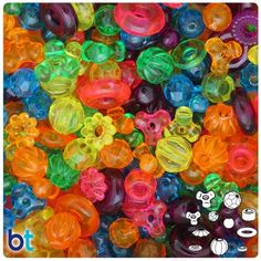 lots of different colored beads are in the shape of flowers and circles on a white background