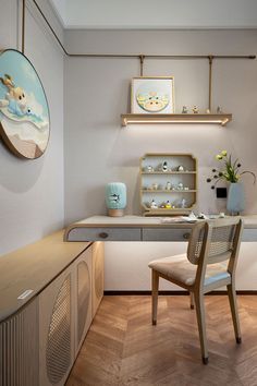 a room with a desk, chair and shelves on the wall next to each other