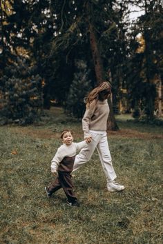 a mother and child playing in the grass