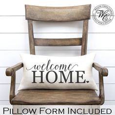 a welcome home pillow sitting on top of a wooden chair