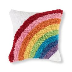 a rainbow pillow on a white background