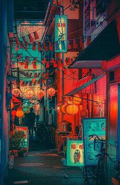 an alleyway at night with chinese lanterns hanging from the ceiling