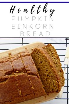 a loaf of pumpkin bread on top of a wooden cutting board with the words healthy pumpkin einkorn bread