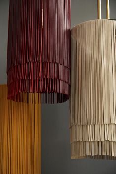 three different colored lamps hanging from the ceiling