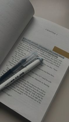 a pen sitting on top of an open book