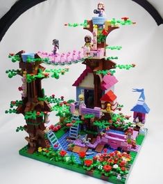 a lego tree house with people on the roof