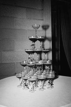 a table topped with lots of wine glasses