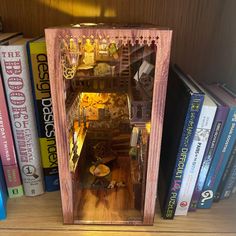 an open book case sitting on top of a wooden shelf