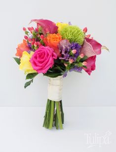 a bouquet of colorful flowers in a white vase