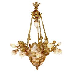 an antique chandelier with glass flowers and leaves on the bottom half of it