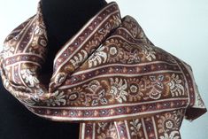 A beautiful traditional men's or women's scarf from the 60s in a striking brown paisley. Doubled, silk on one side and the finest wool challis (not sure...usually this is the case but this may be a blend or could be rayon...very pleasing, whatever it is and non-scratchy) in rich solid (milk chocolate) brown on the other. Size is 53 x 10 inches Fluffy short fringe. No matting. Condition is excellent. Classic Brown Scarf For Formal Occasions, Classic Brown Silk Scarf, Vintage Brown Silk Scarf For Gift, Traditional Brown Silk Scarves, Vintage Brown Winter Scarf, Brown Vintage Winter Scarves, Luxury Brown Classic Silk Scarf, Brown Traditional Patterned Scarves, Vintage Brown Winter Scarves