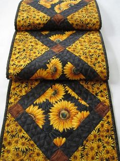 three sunflowers on black and yellow quilted placemats