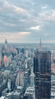 an aerial view of new york city with skyscrapers and other buildings in the background