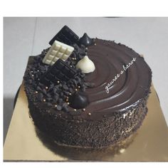 there is a chocolate cake with icing on the top that has an image of a train coming out of it