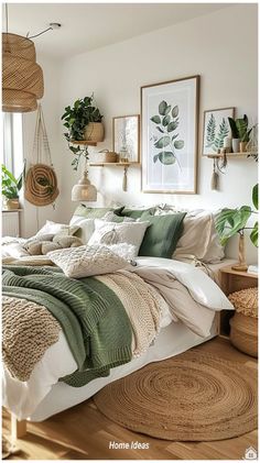 a bed with green and white blankets in a bedroom next to potted plants on the wall