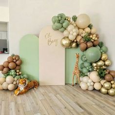 a room decorated with balloons and jungle animals