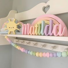 there is a wooden sign that says madam on the shelf next to a toy sun