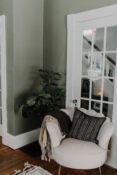 a white chair sitting in front of a doorway