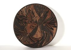 a wooden plate with an image of a bird on it