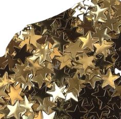 gold and black star confetti on white background