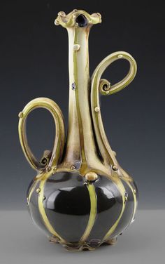 a black and gold vase sitting on top of a table