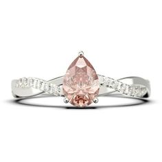 a pink diamond ring with white diamonds on the band and an oval shaped stone in the center