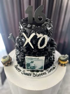 a black and white cake with the number sixteen on it