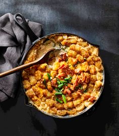 a skillet filled with food sitting on top of a table next to a napkin