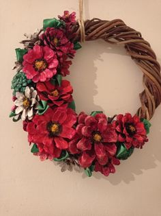 a wreath with flowers hanging on the wall