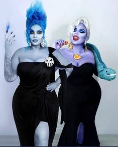 two women dressed in black and blue are posing for the camera