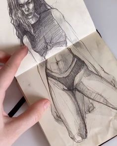 a person is drawing on paper with a pen and inking it onto a piece of paper