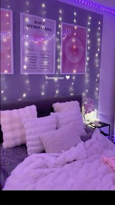 a bed room with a neatly made bed and some lights on the wall above it