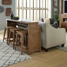 a living room filled with furniture and a flat screen tv on top of a wooden table