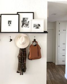 there is a hat, coat rack and purse on the wall in this living room