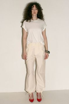 Loosely tailored cargo pant in a soft yet structured cotton. Straight leg with tie at ankle, cinch for a more tapered silhouette. Side pockets and oversized patch pockets above knee. Made in New York City. Fabric is 100% cotton. Avery is 5'10", bust 31", waist 24", hip 35", and is wearing a size S. Spring Cargo Style Parachute Pants, Utility Cotton High-waisted Parachute Pants, Spring Workwear Cargo Pants With Patch Pockets, Cotton Wide-leg Cargo Pants With Pockets, Spring Cotton Cargo Pants With Cargo Pockets, Relaxed Fit Straight Cargo Pants, Spring High-waisted Cargo Pants With Pockets, Summer High-waisted Parachute Pants With Multiple Pockets, Spring Straight Cargo Pants With Multiple Pockets