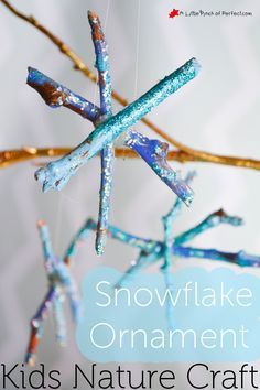 a snowflake ornament made out of branches with blue and gold paint