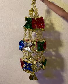 a person is holding up a christmas decoration