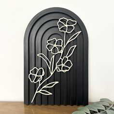 a metal art piece with flowers on it