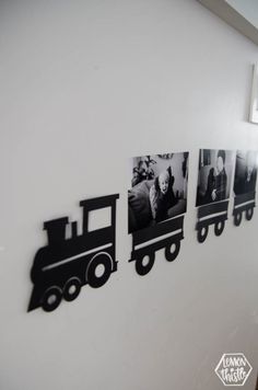 some black and white photos hanging on the wall next to a train shaped cutout