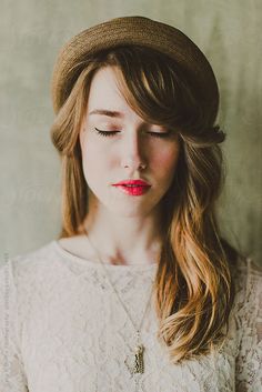 a woman with long hair wearing a hat