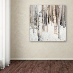 an empty room with a painting on the wall and wood flooring in front of it