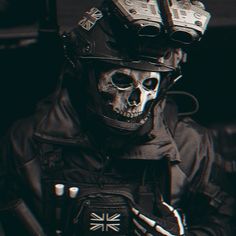 a man wearing a helmet and holding a cell phone in his hand with the british flag painted on it