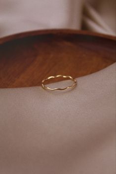 Effortlessly enhance your style with this dainty 14k Gold Wavy Ring. Extremely comfortable and lightweight. This stunning piece will give you a unique, hand-crafted and fresh new look. Whether its work or social, this ring will certainly compliment the occasion! Wear independently or stacked with other rings! Details * Handmade and designed using 14K Gold Filled * Designed and produced using the highest quality and care, allowing for fantastic durability and sustainability. * Beautifully package Adjustable Wavy Promise Rings, Minimalist Wavy Rings As A Gift, Minimalist Wavy Rings For Gift, Minimalist Wavy Rings As Gifts, Gift Wavy Stackable Rings, Gift Stackable Wavy Rings, Wavy Ring, Gold Wave Ring, Ring Everyday