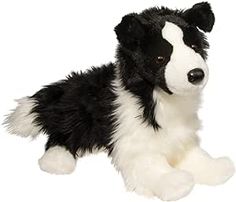 a black and white stuffed dog laying down