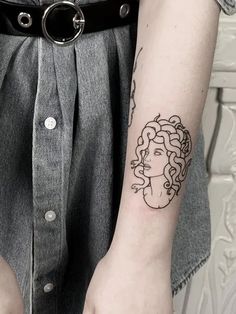 a woman with a tattoo on her arm