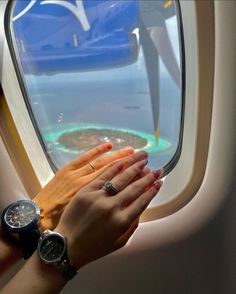 a woman's hand on the arm of an airplane window