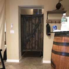 a bathroom with a wine barrel and wooden door