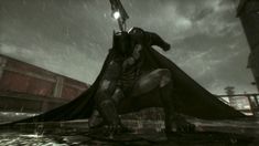 a man dressed as batman standing in the rain