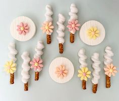 there are many flowers on the top of these popsicles that look like they have been made out of paper